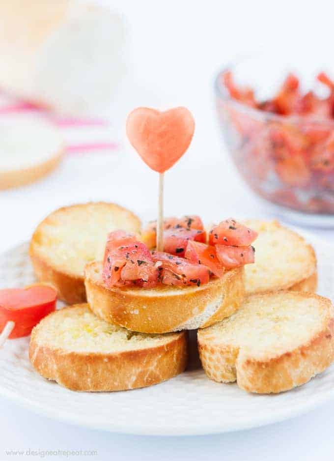 Use a mini heart cookie cutter to turn ordinary bruschetta into a festive Valentine's appetizer! Check out the recipe on the Design Eat Repeat blog!