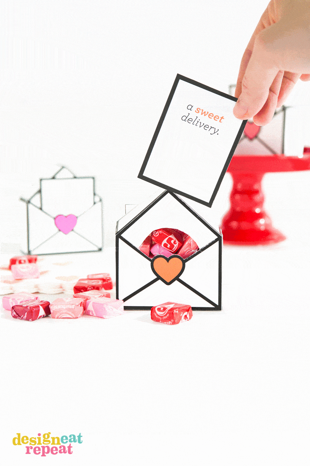 A gif of printable Valentines gift boxes that show the card popping up to reveal the candy inside.