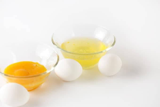 Bowls of separated egg whites and egg yolks