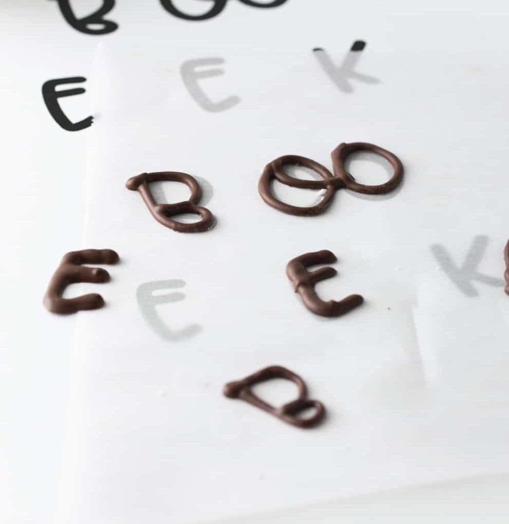 Sheet of chocolate letters to make edible Halloween cupcake toppers. Boo and EEK phrases.