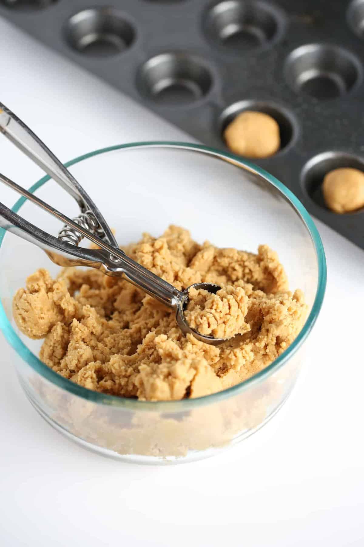 Bowl of peanut butter cookie dough to make easy Christmas holly cookie cups!