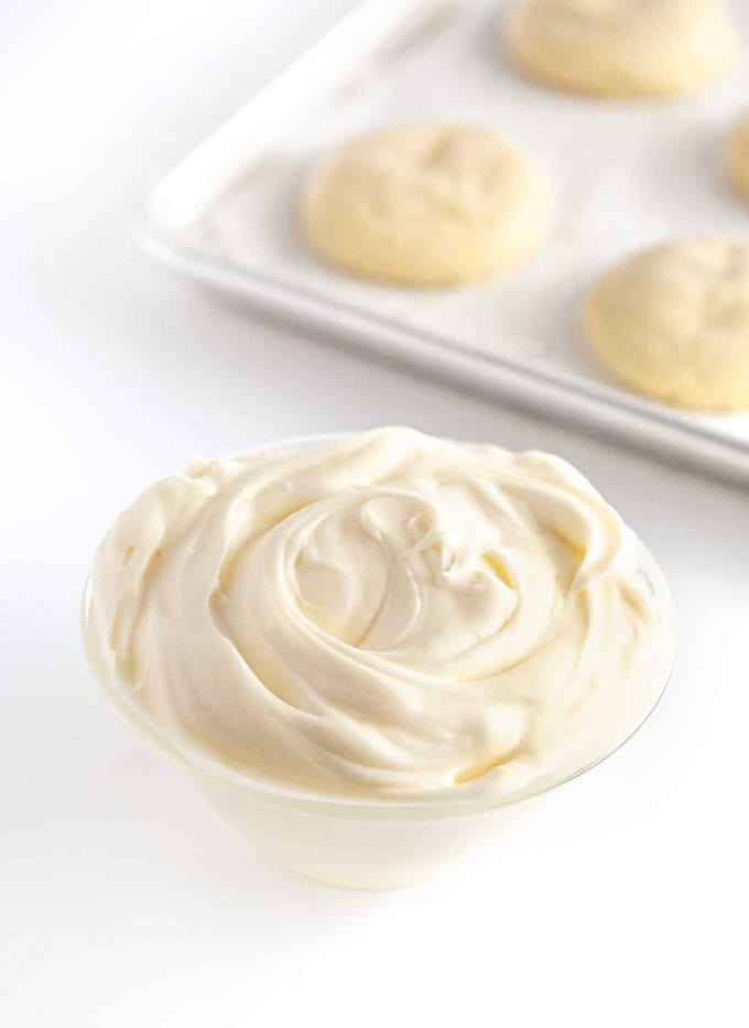Bowl of white cream cheese frosting for sugar cookies