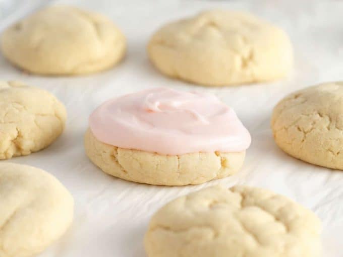 sugar cookies topped with pink cream cheese frosting for cookies