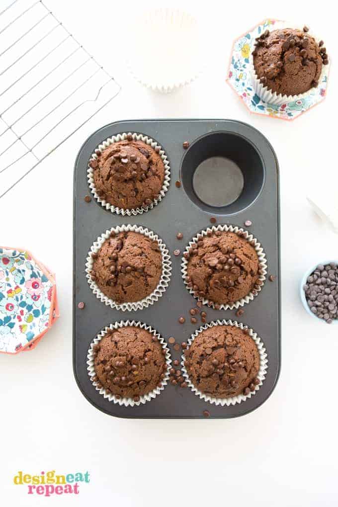 Overhead shot of six Sumbo Double Chocolate Zucchini Muffin in cupcake pan.