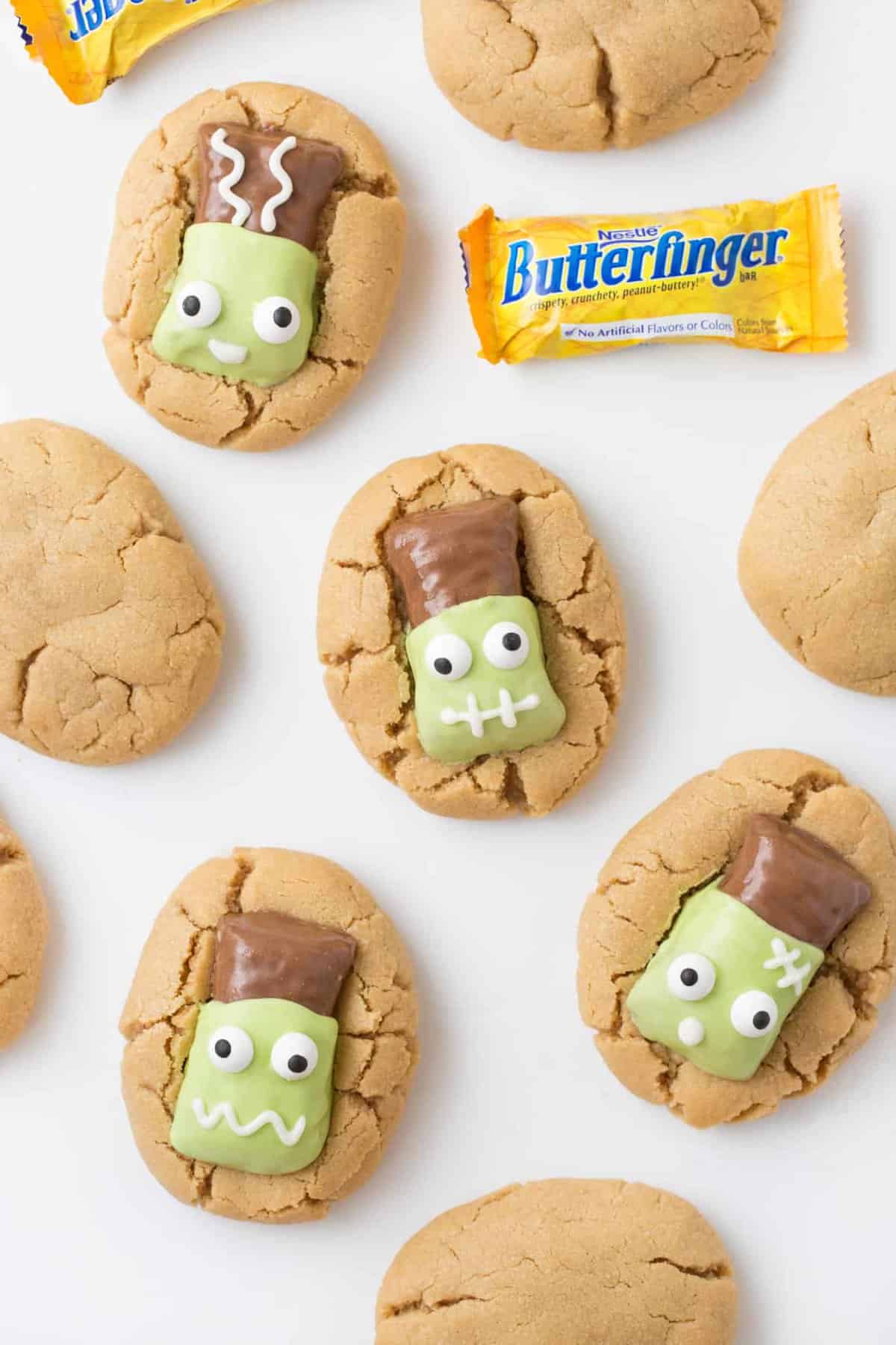 Peanut butter cookies topped with Butterfinger fun size candy bars that have been decorated to look like Frankenstein.
