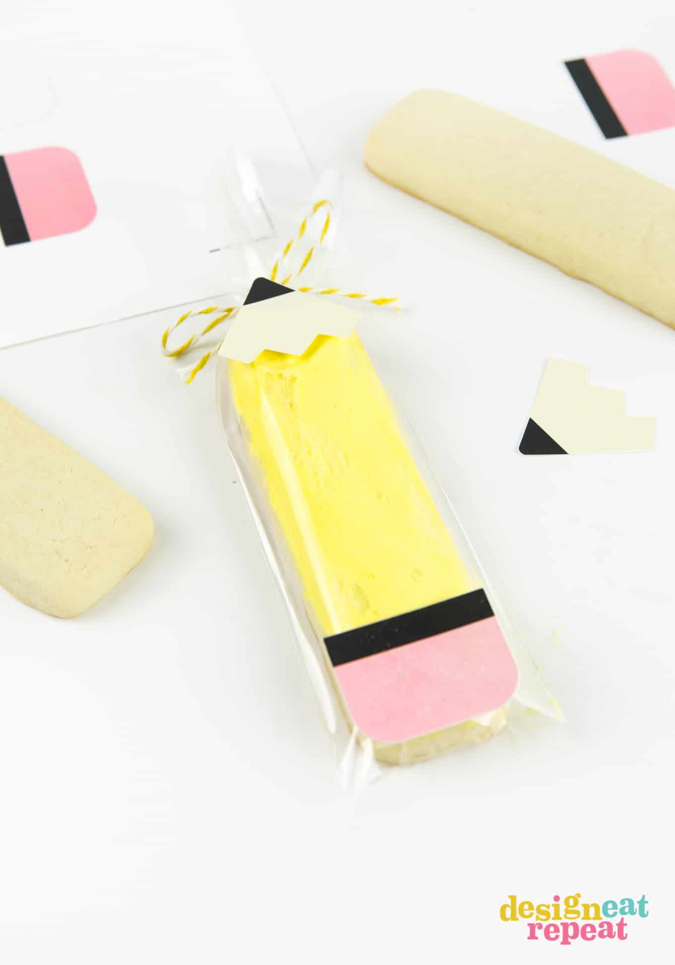 Yellow sugar cookie stick inside clear bag and decorated like pencil using printables.