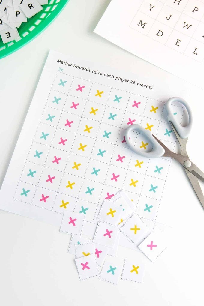 Sheet of colorful printable alphabet bingo markers being cut out