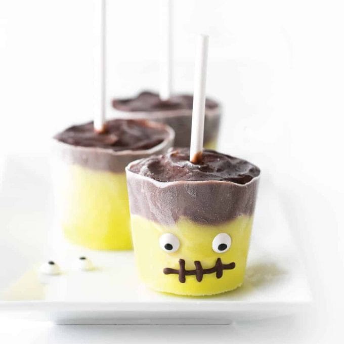 Frankenstein pudding pops with eyeballs and chocolate mouth.