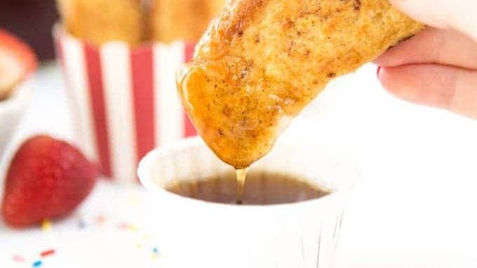 Hand dipping french toast sticks