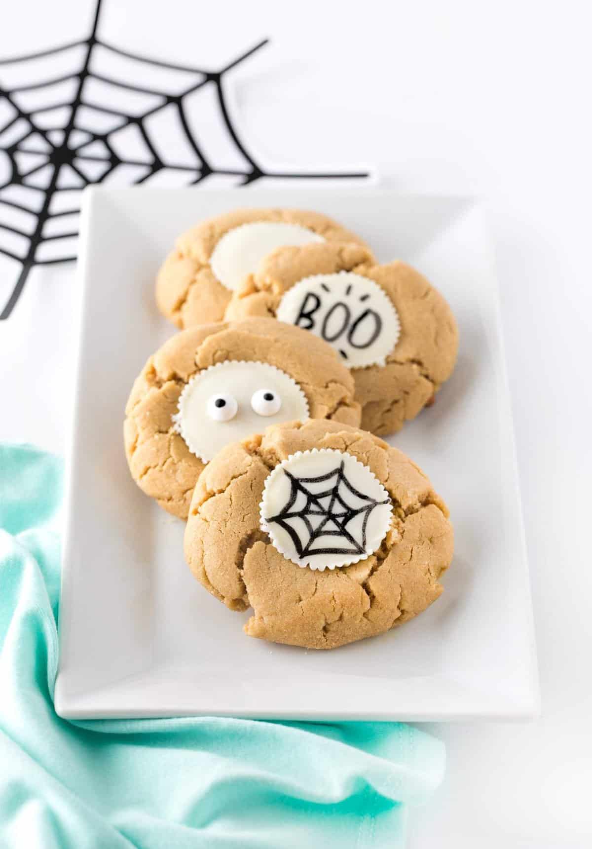 Forget the fancy decorating and grab the edible food pen to draw-your-own easy Halloween cookies! Using a traditional peanut butter cup as the "canvas", you can customize with your own icons, faces or spooktacular phrases! #Halloween | #Cookies | www.DesignEatRepeat.com