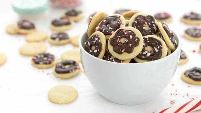 White bowl of peppermint wafer cookies for Christmas candy.