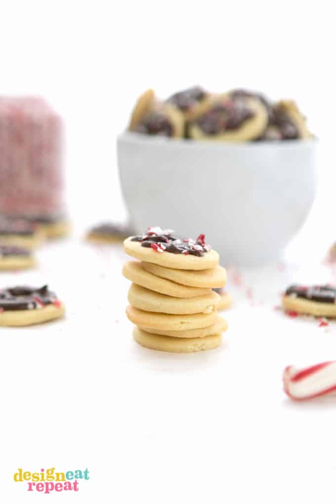 Stack of chocolate peppermint butter wafer cookies with crushed peppermint bits on top.