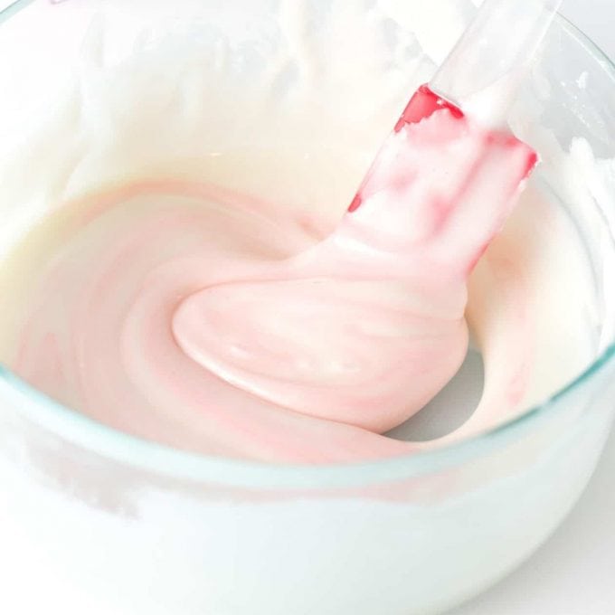 stirring pink icing