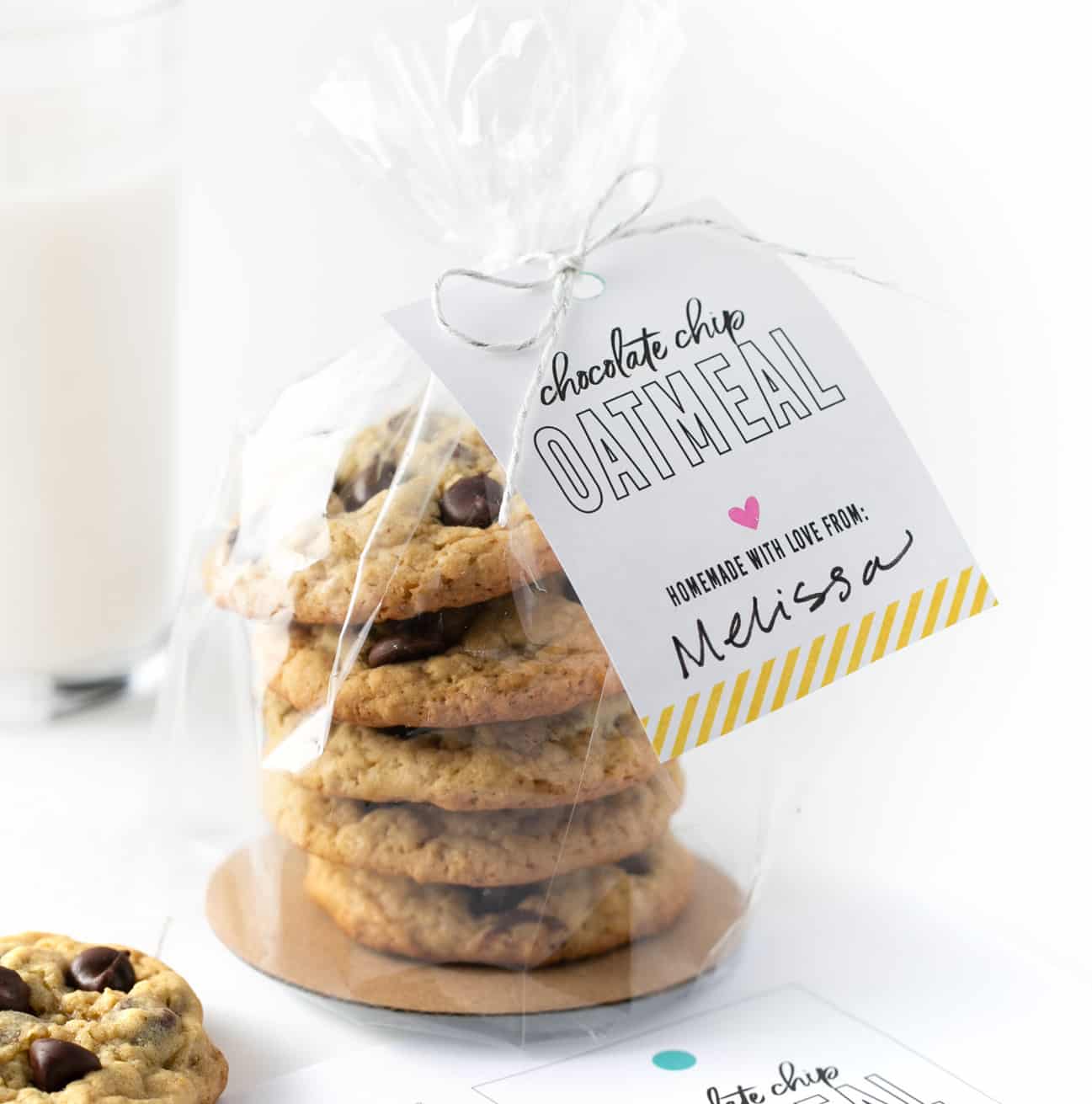 stack of chocolate chip oatmeal cookies packaged in plastic bag with gift tag