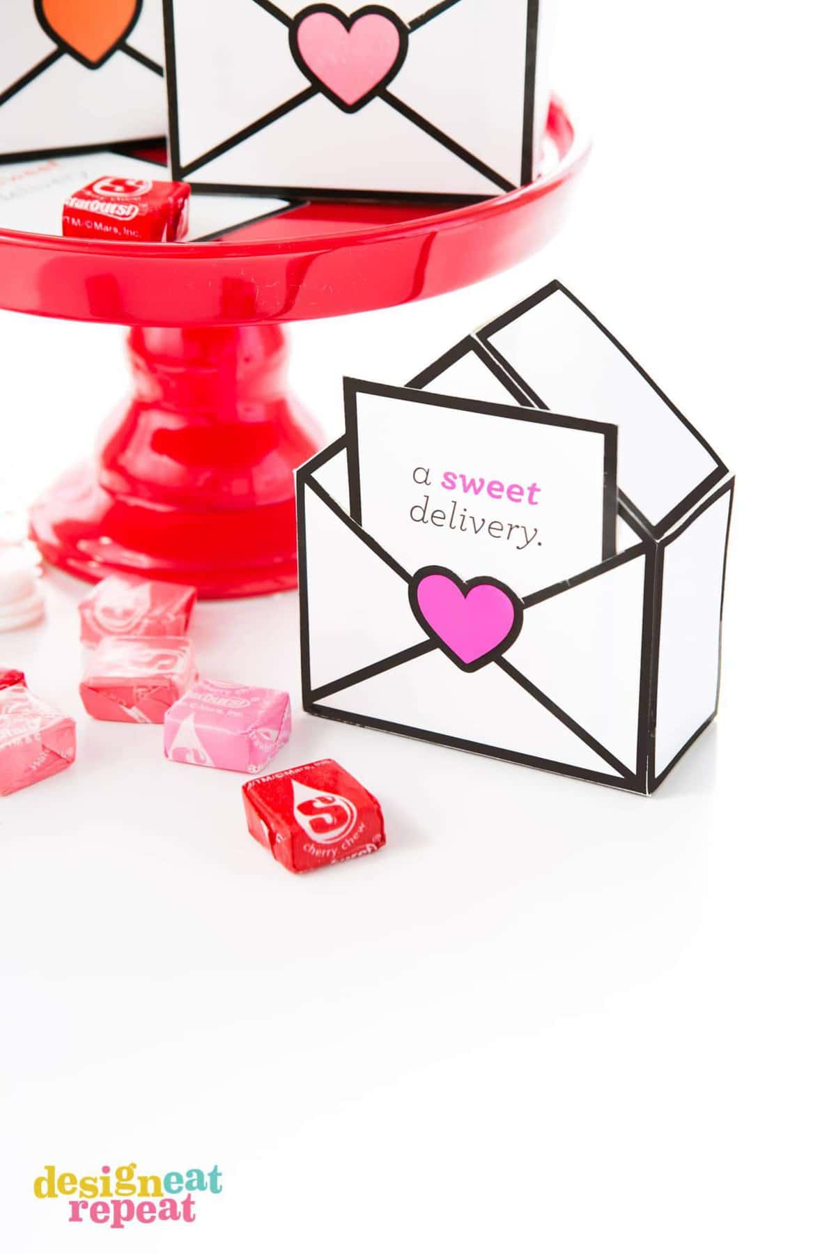 Printable Valentines gift boxes that are designed like envelopes with a sweet delivery notecard filled with Starburst.