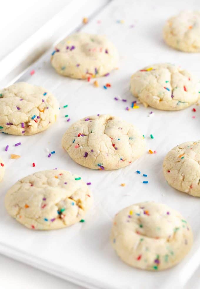 Baking tray of baked sugar cookies with sprinkles