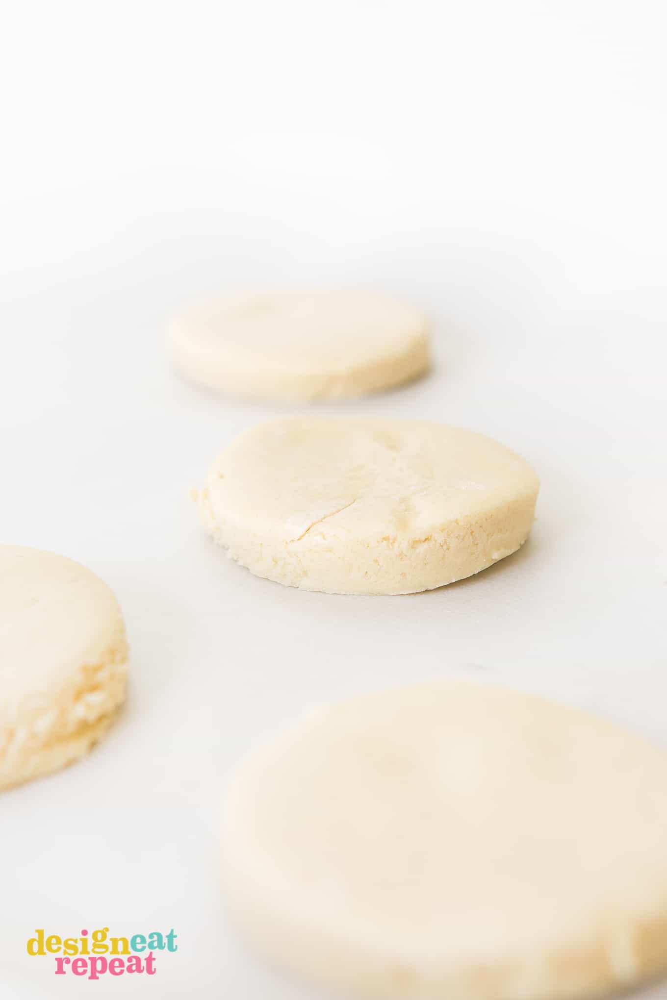 Raw sugar cookie dough on parchment paper before baking.